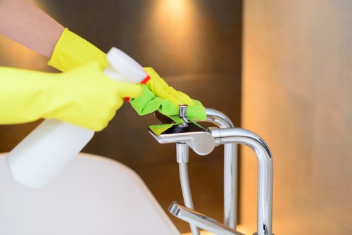 Technician cleaning a carpet in a Balham flat using hot water extraction equipment